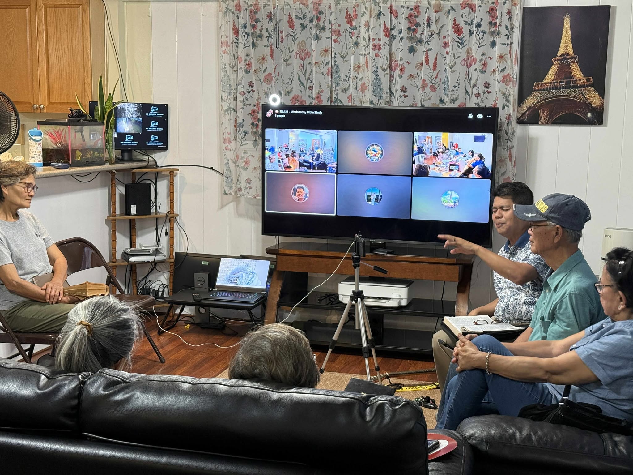 Members joining Wednesday Bible Study virtually on a large TV screen