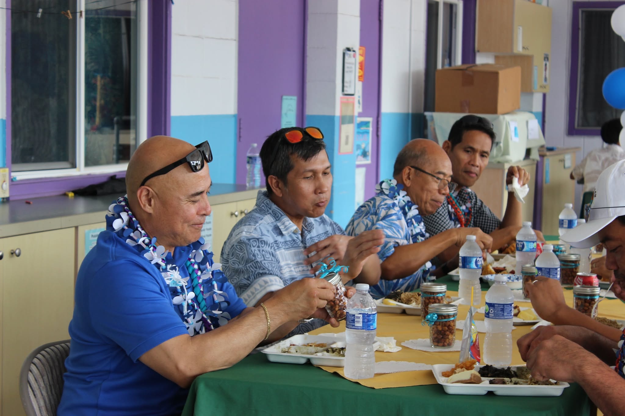Men dining together with leis at the Connect and Dine gathering