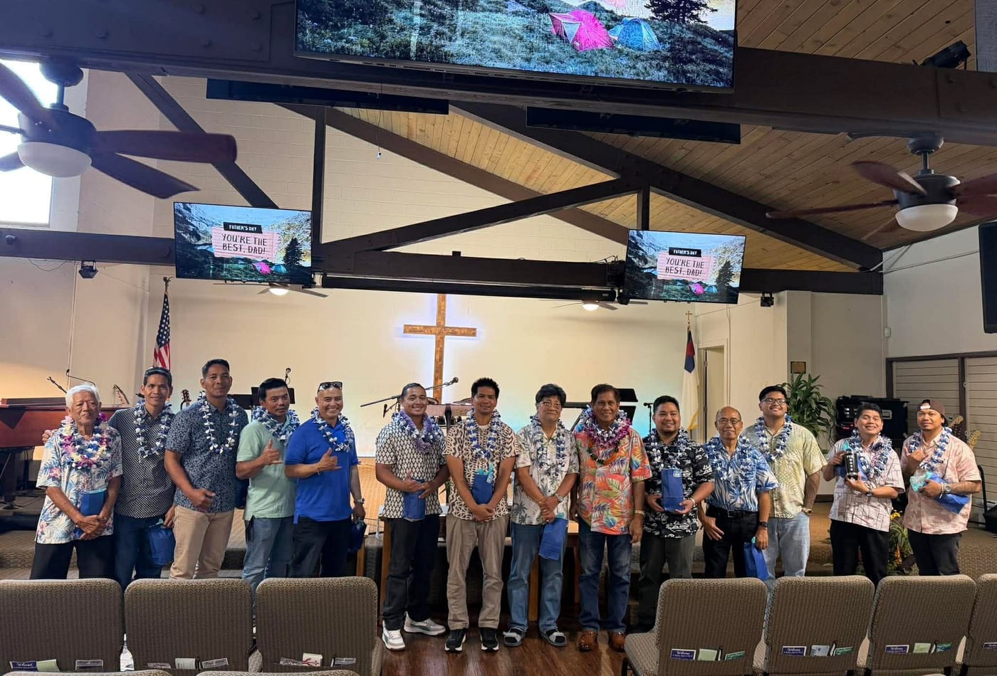 Men wearing leis gathered in the sanctuary for Father's Day celebration