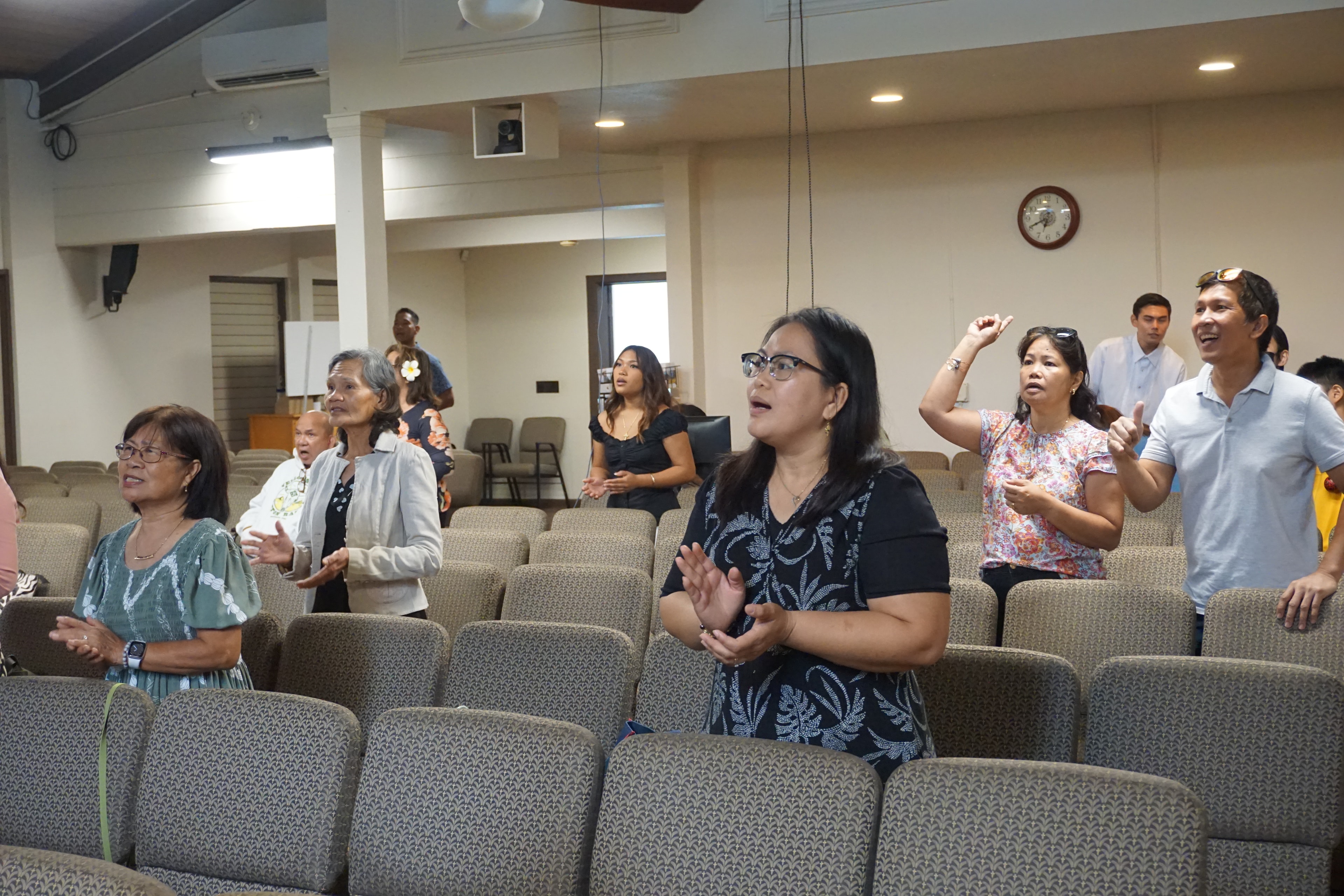 Congregation members singing and praising during worship
