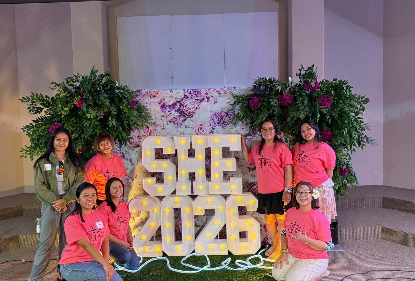 Women in pink shirts at the SHE 2026 women's ministry event